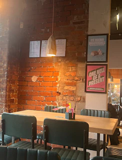 A cozy café scene with customers enjoying artisanal dishes, framed by matte forest green walls.