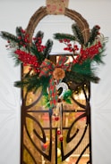 Seasonal door swag featuring resin accents and natural elements.