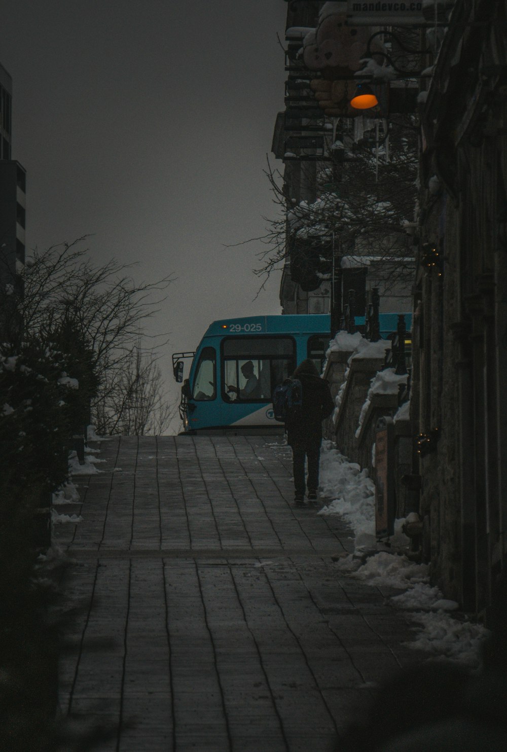 a blue bus parked on the side of a road