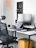 A sleek modern office chair in a bright, airy workspace with African-inspired decor.