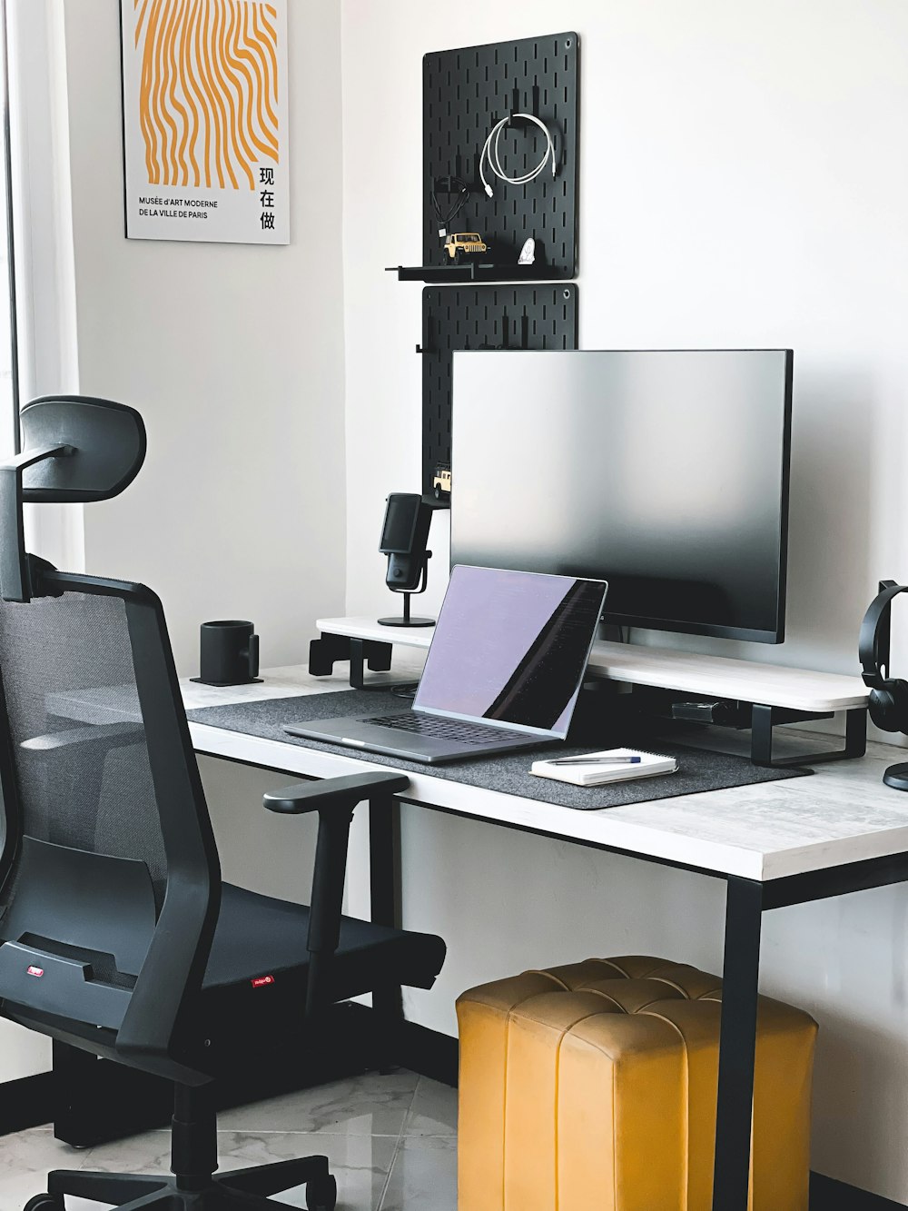 a desk with a laptop and a monitor on it