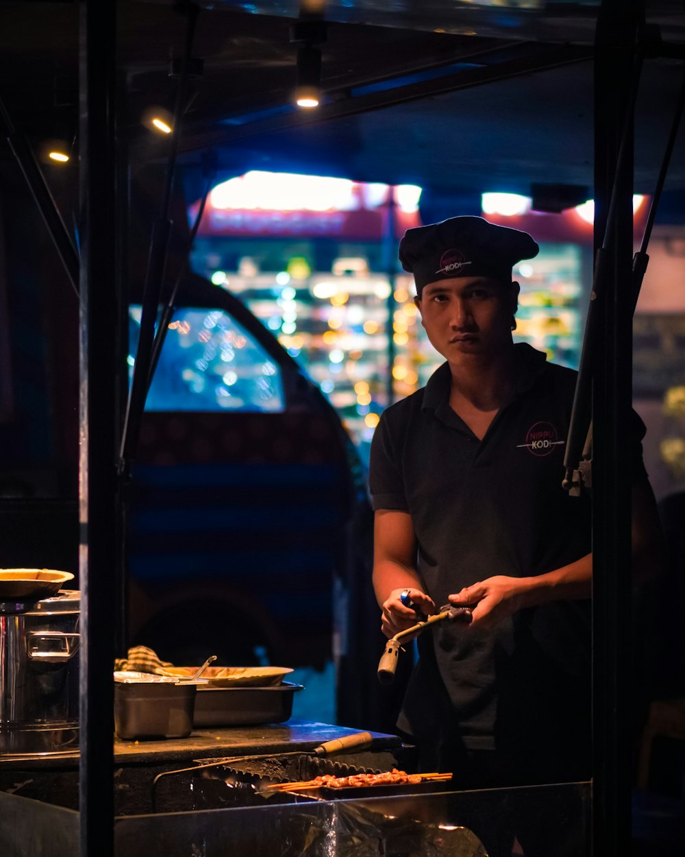 a man cooking food on a grill in a restaurant