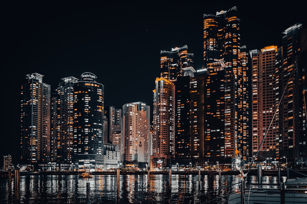 a night scene of a city with tall buildings