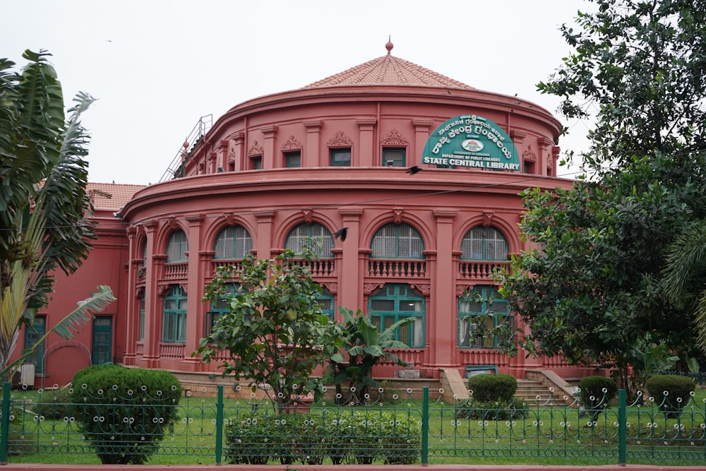 a red building with a green fence around it