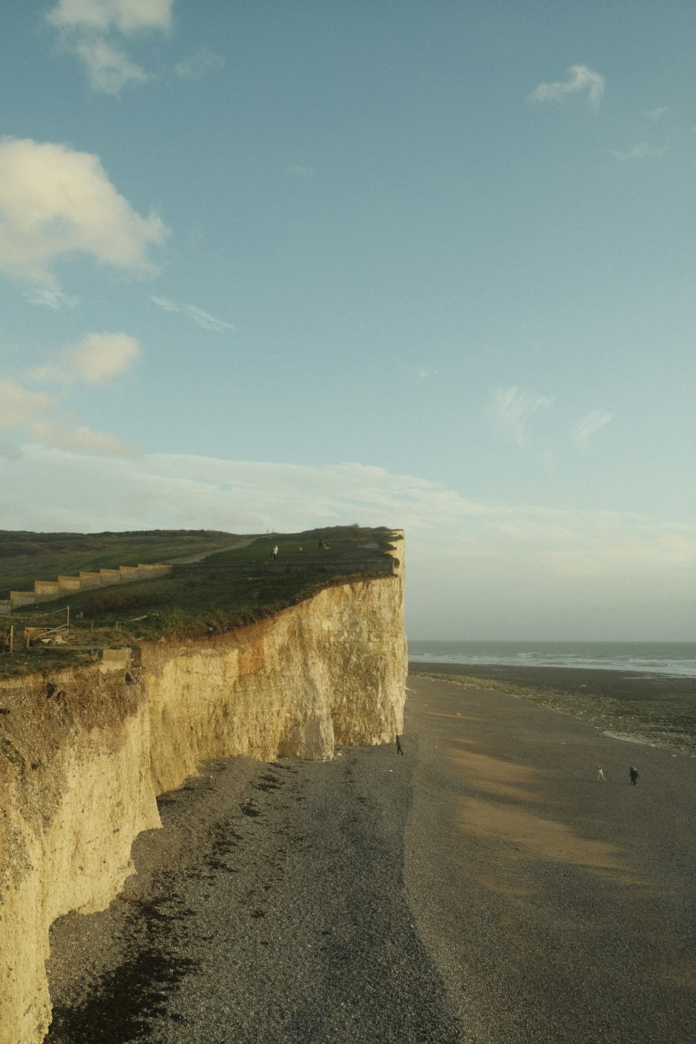 a large cliff on the side of a beach