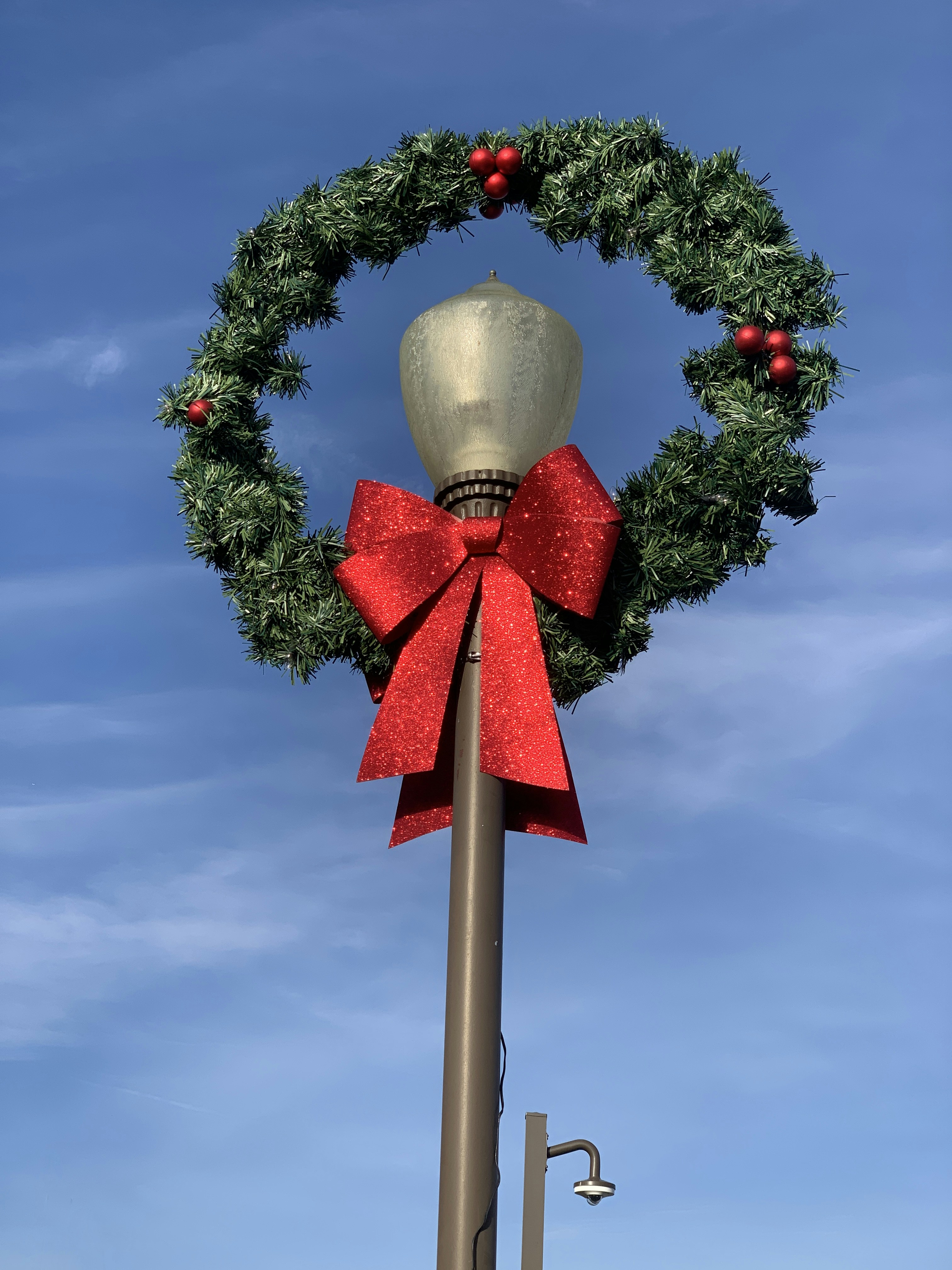 a christmas wreath on top of a pole