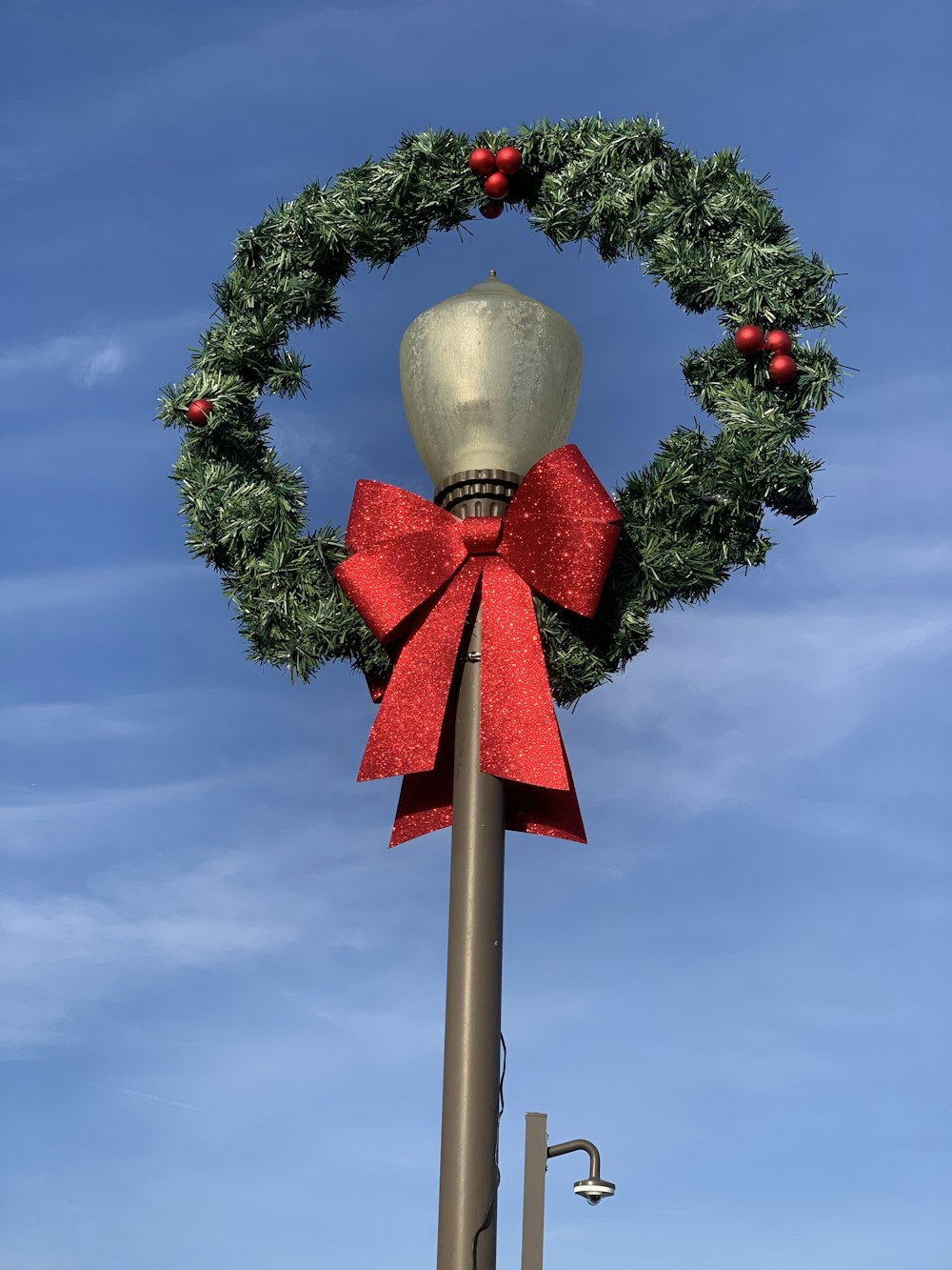 a christmas wreath on top of a pole