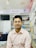 A customer smiling while reviewing their latest purchase from Photonics Global.