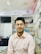 A customer smiling while reviewing their latest purchase from Photonics Global.