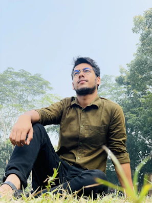 A boy wearing sporty green glasses, exploring nature with curiosity.