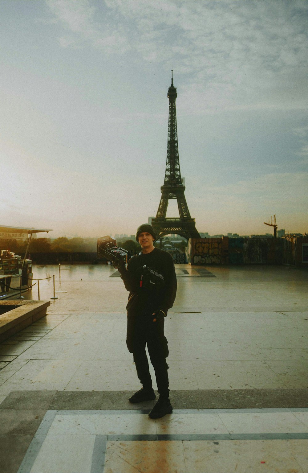 a man standing in front of the eiffel tower