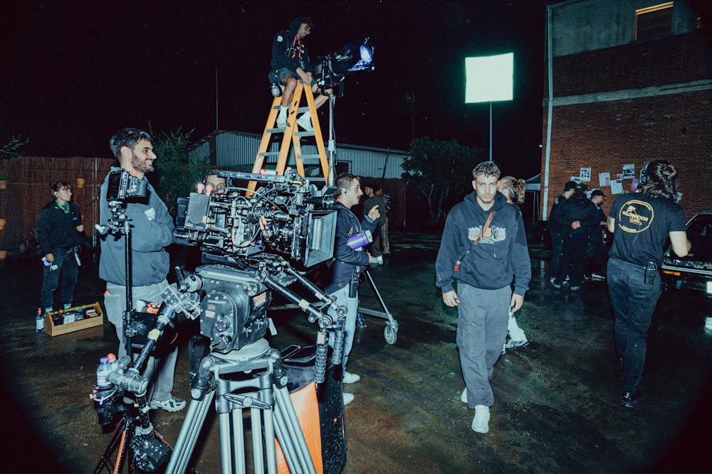 a group of people standing around a camera