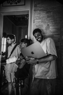 A family happily using a laptop together, surrounded by digital icons representing photos, documents, and data storage.
