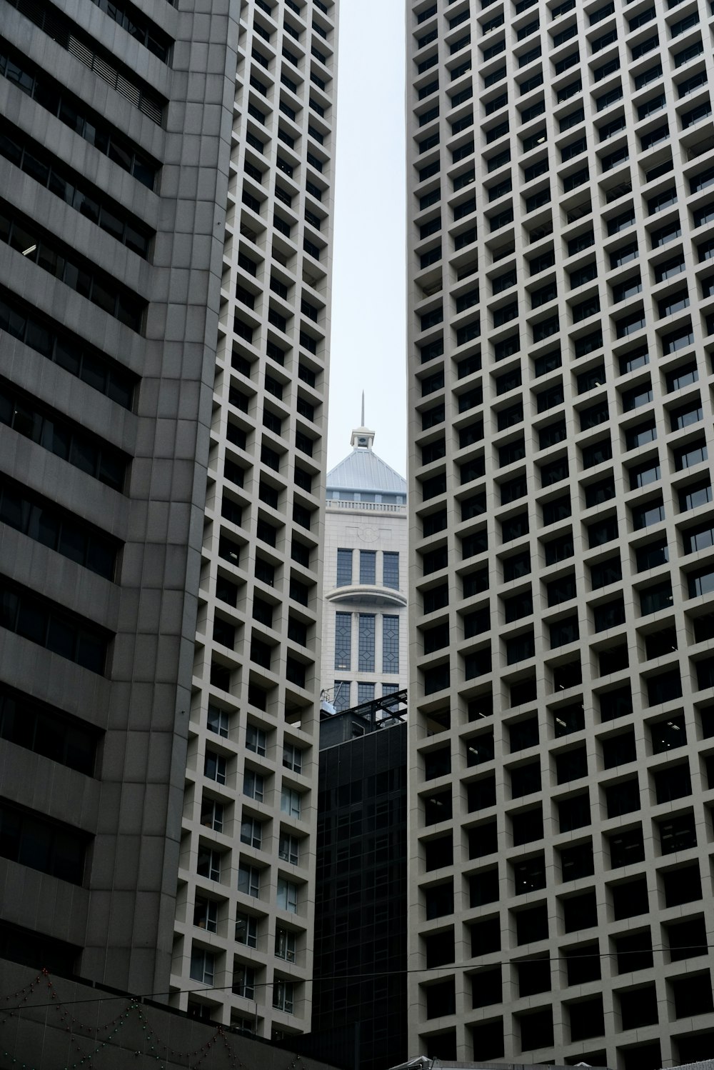 a couple of tall buildings sitting next to each other