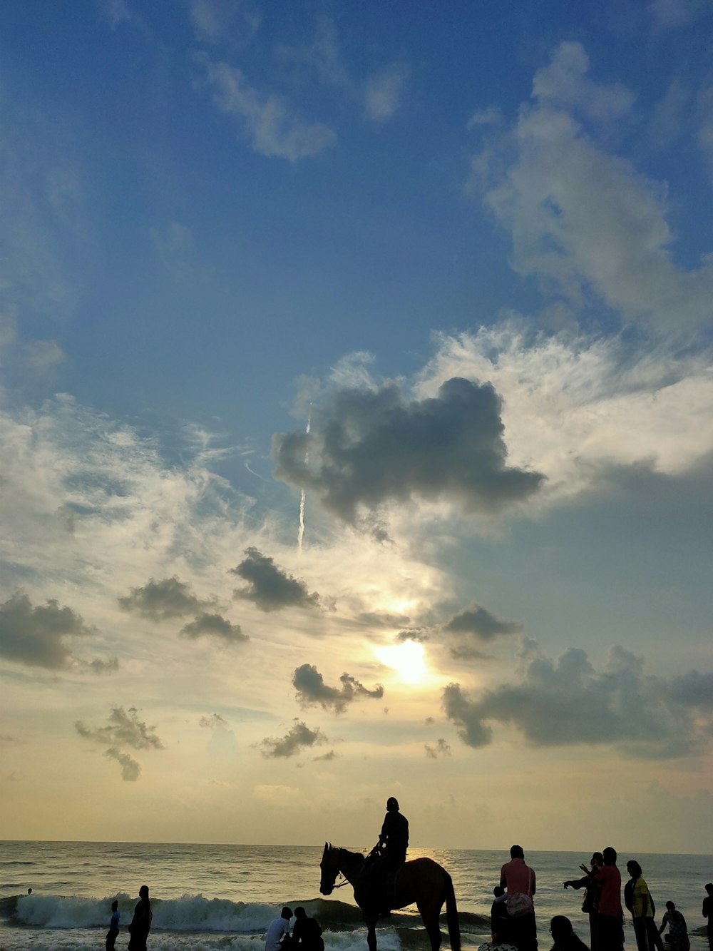 a person riding a horse on the beach