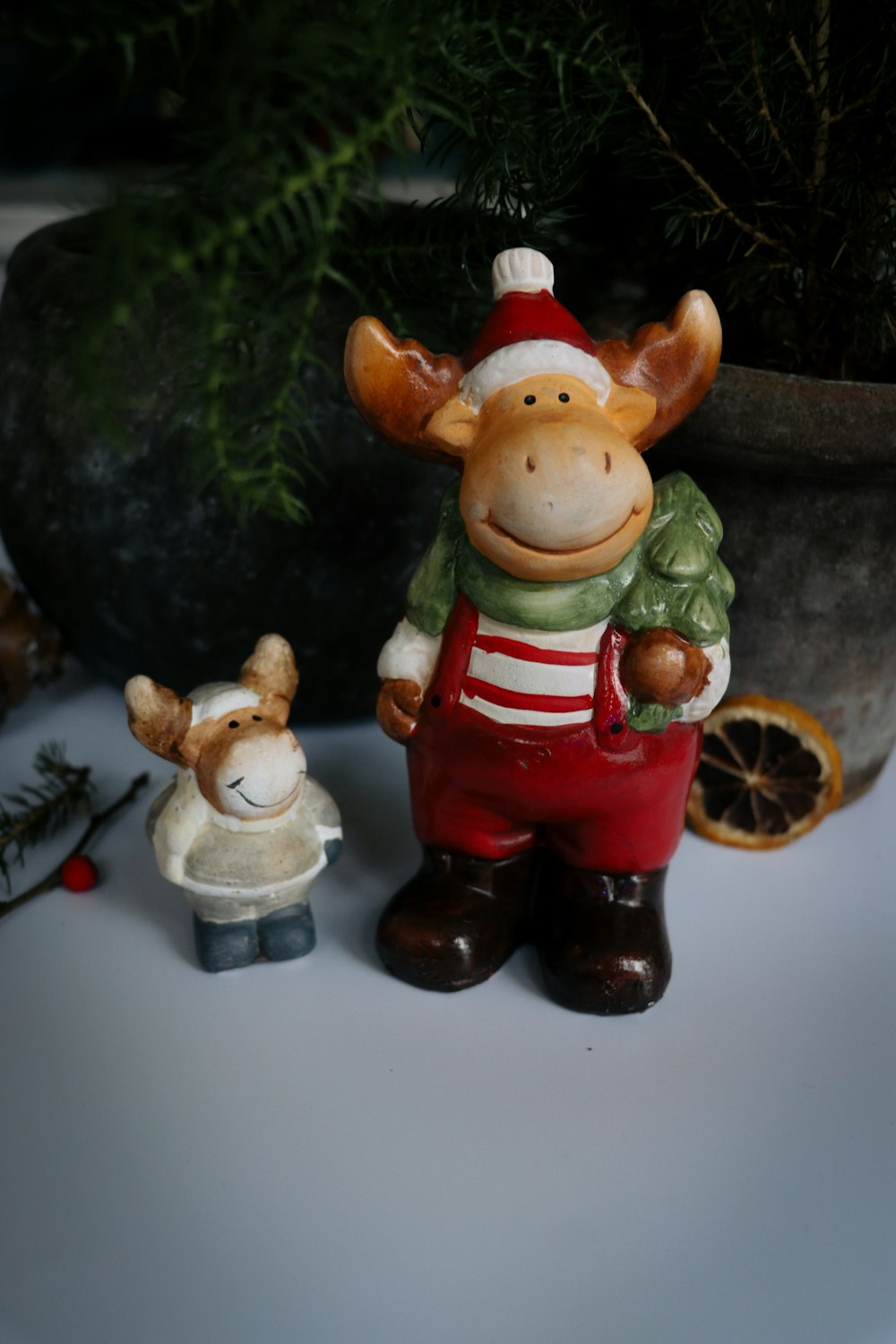 a ceramic figurine of a cow and a deer