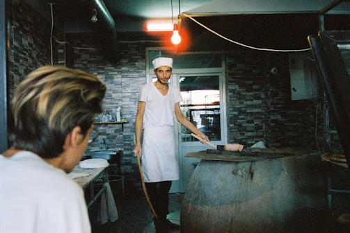Technician carefully repairing an oven in a cozy Dallas kitchen.