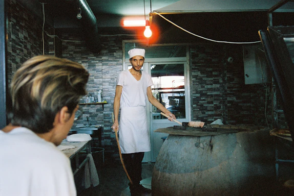 A skilled technician repairing a gas oven in a cozy kitchen setting.