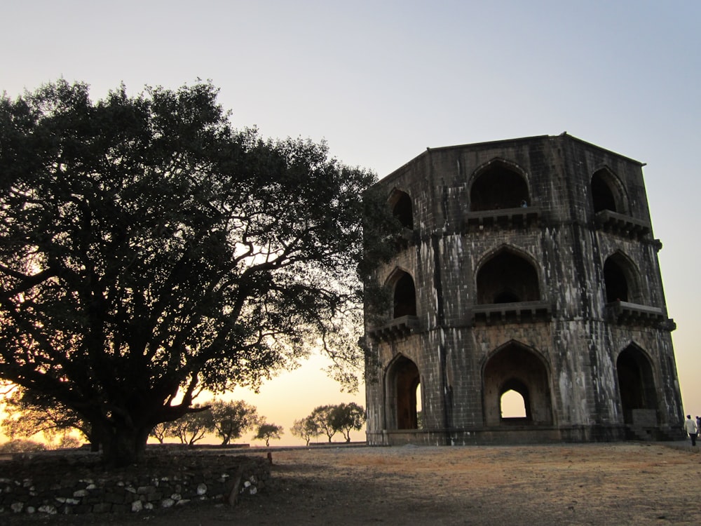 an old building with a tree in front of it