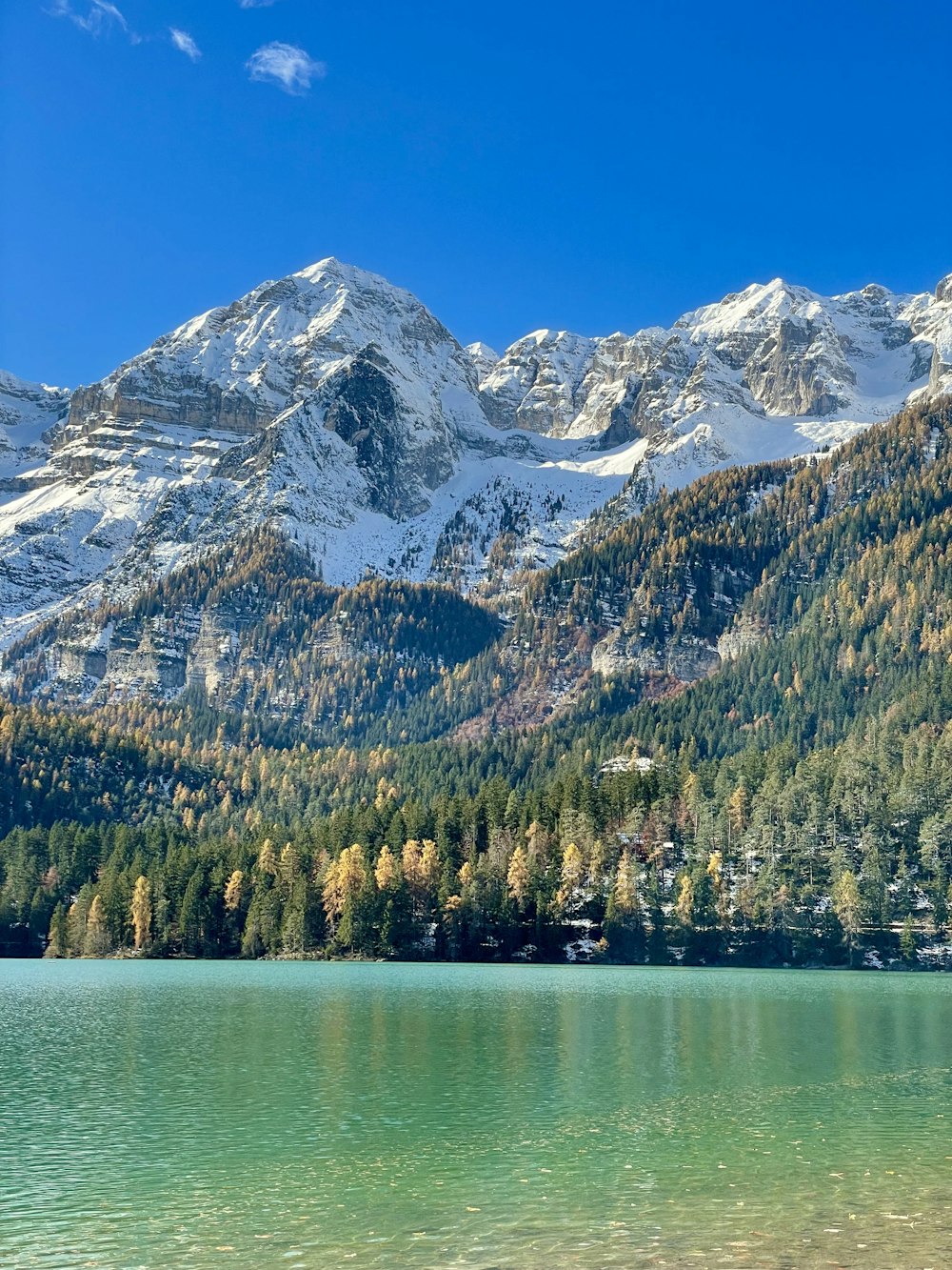 a mountain range with a lake in the foreground