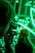 A photographer takes a picture with a camera while vibrant green lights illuminate the background. The scene focuses on a bokeh effect created by the lights, possibly of stringed or decorative type. A person stands in the background, slightly out of focus.