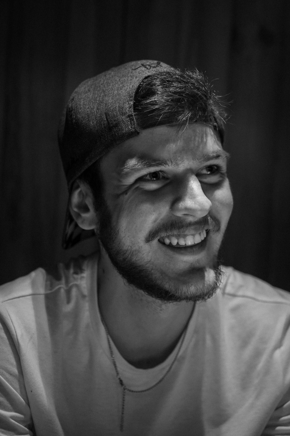 a black and white photo of a smiling man