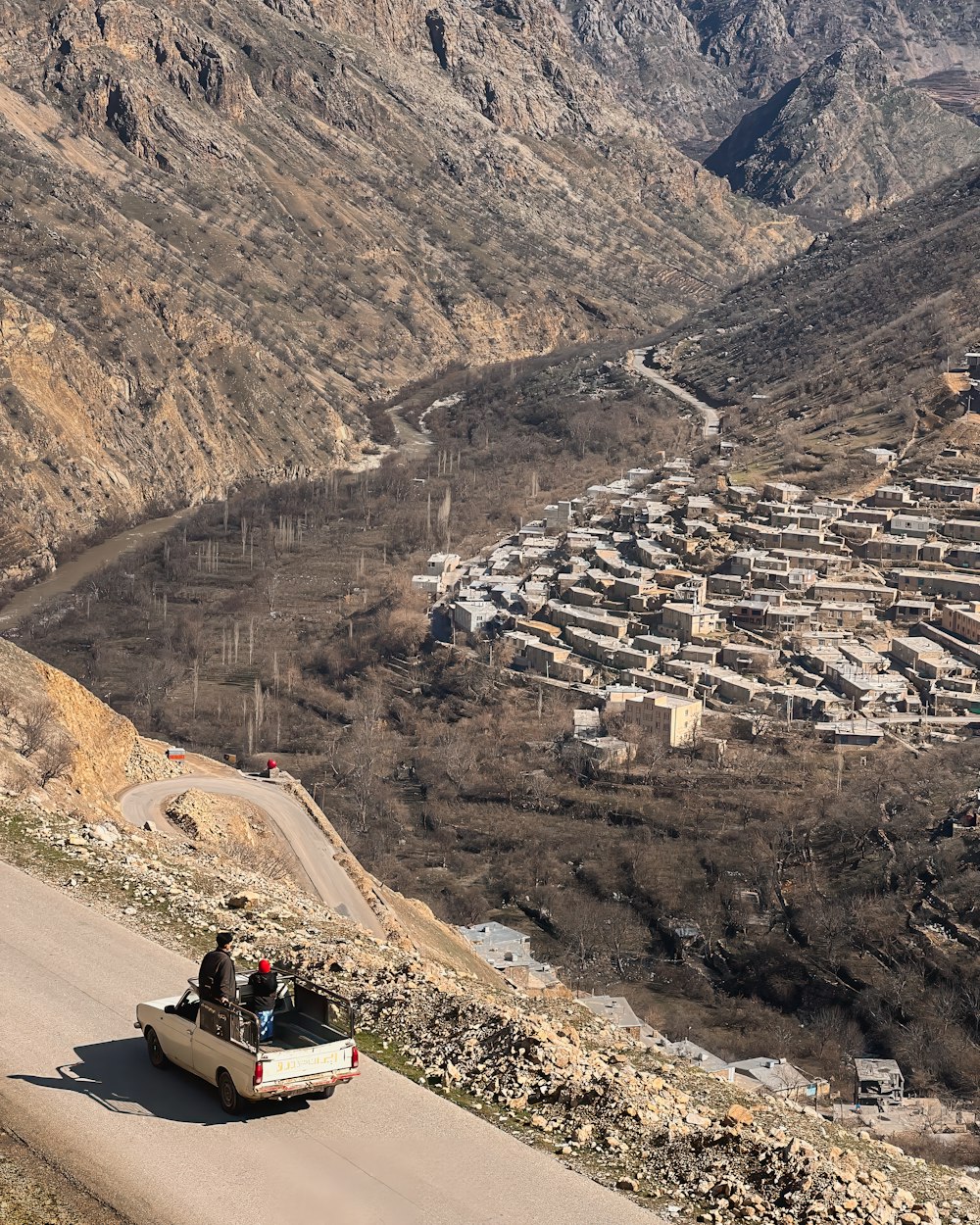 a car driving down a road in the mountains