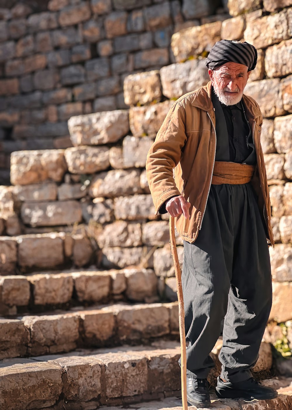 a man in a turban is standing on some steps