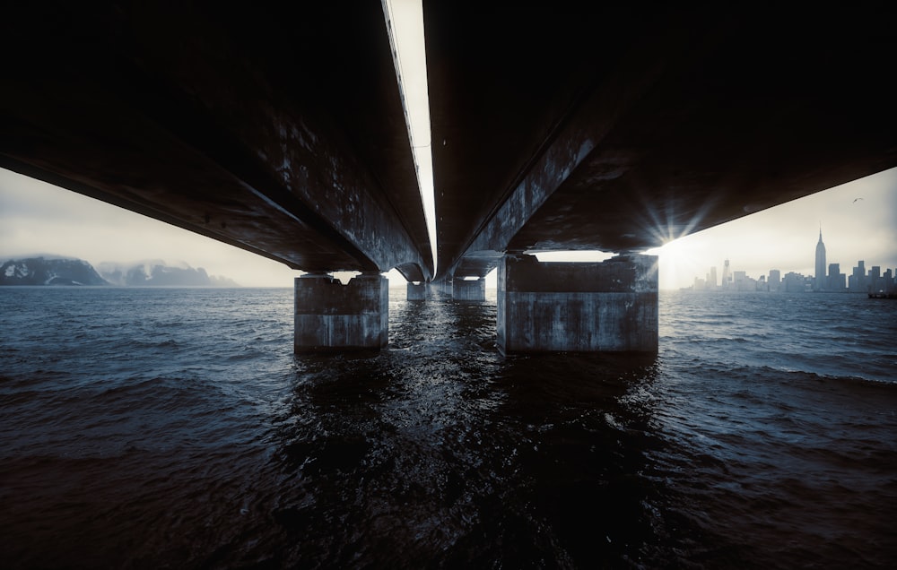 a view of the underside of a bridge over a body of water