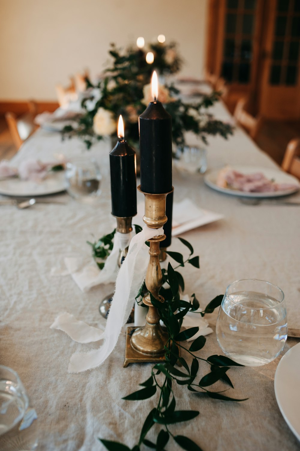 a long table with two candles on it