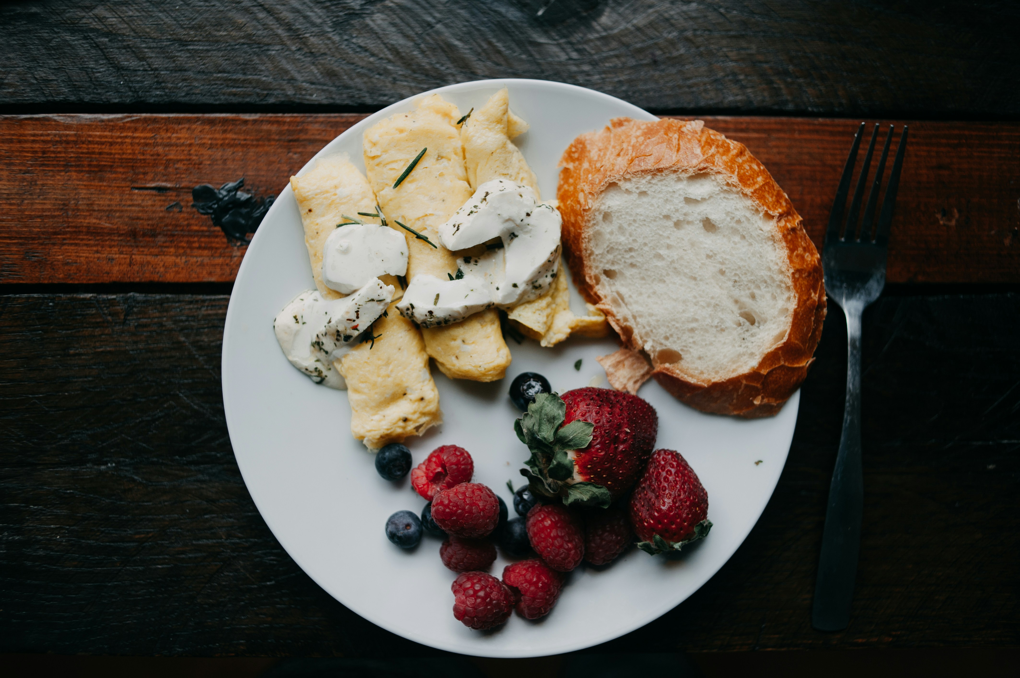 a white plate topped with bread and fruit
