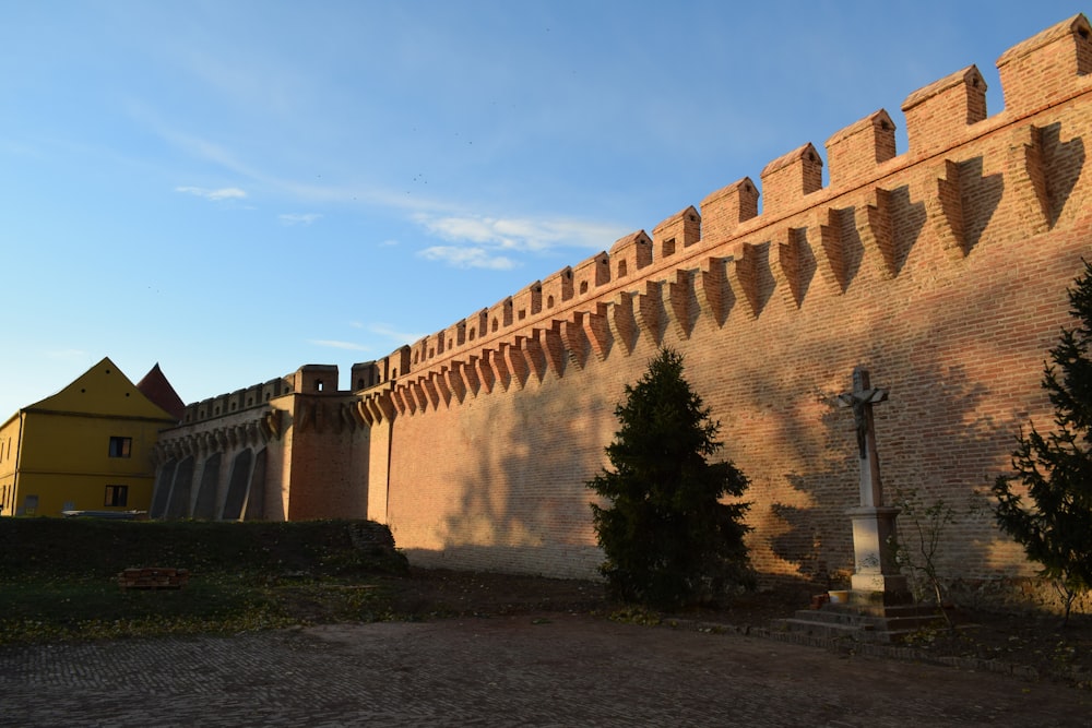 a large brick wall with a clock on it