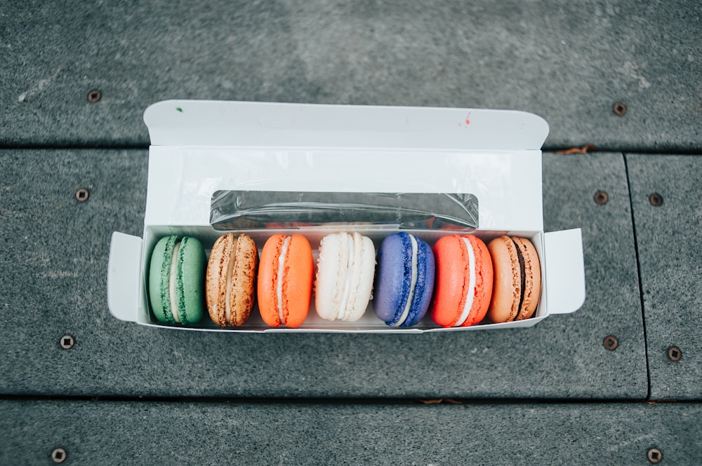 a box of macaroons sitting on a sidewalk