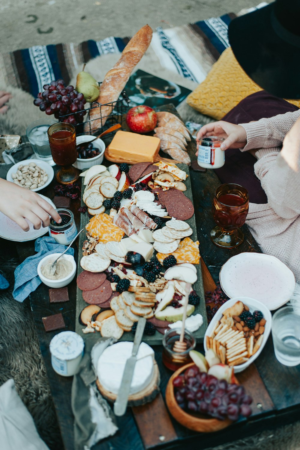 a group of people sitting around a table with food on it