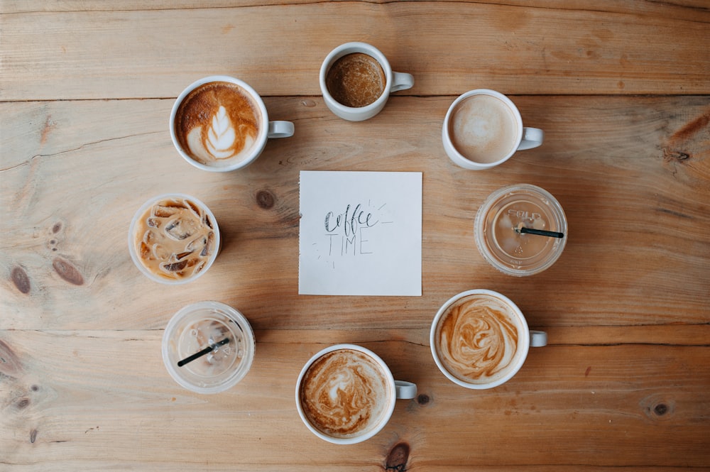 a table topped with lots of cups of coffee