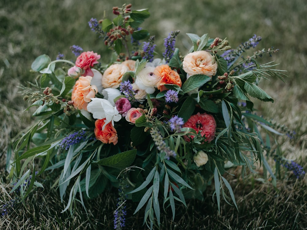 a bouquet of flowers sitting in the grass