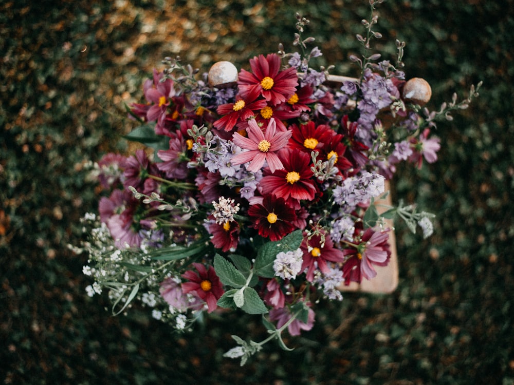 a bouquet of flowers sitting on top of a wooden table