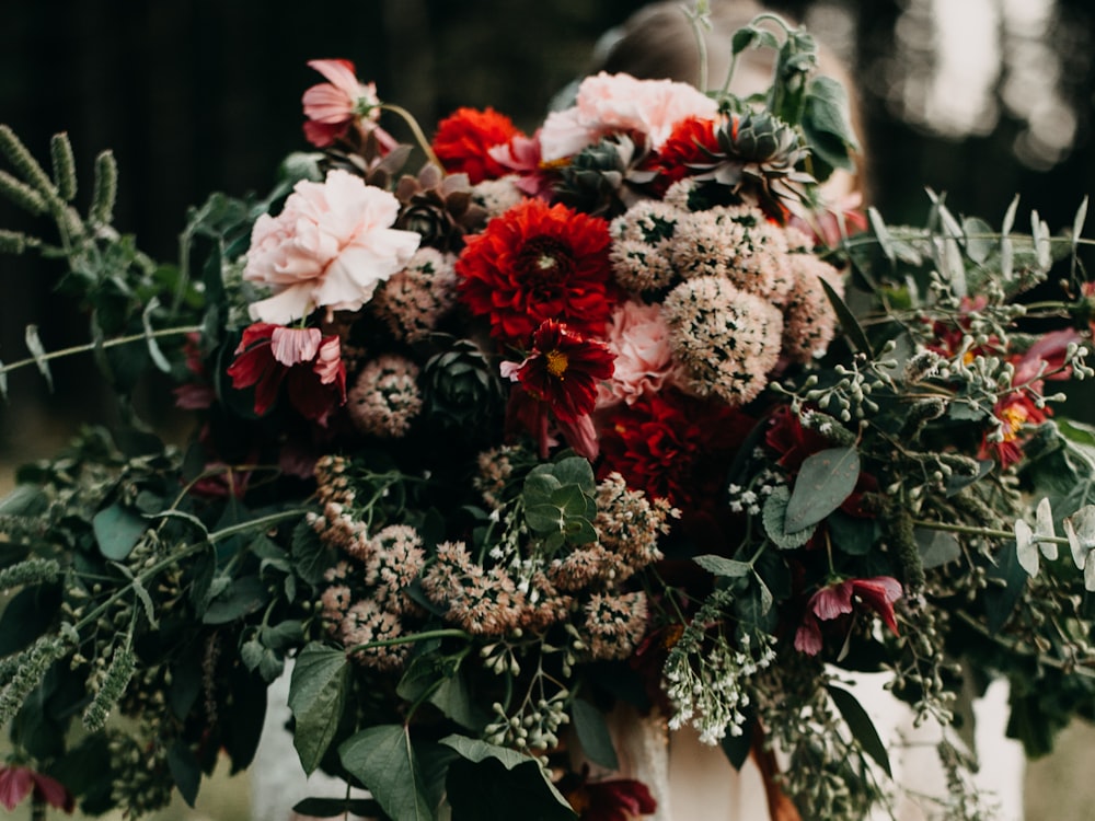 a woman holding a bouquet of flowers in her hands