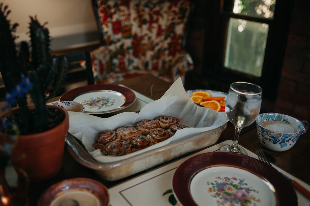 a table topped with plates and bowls filled with food