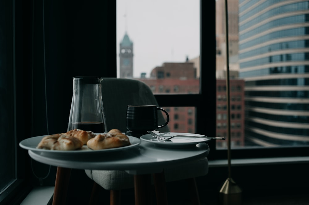 a plate of food on a table in front of a window