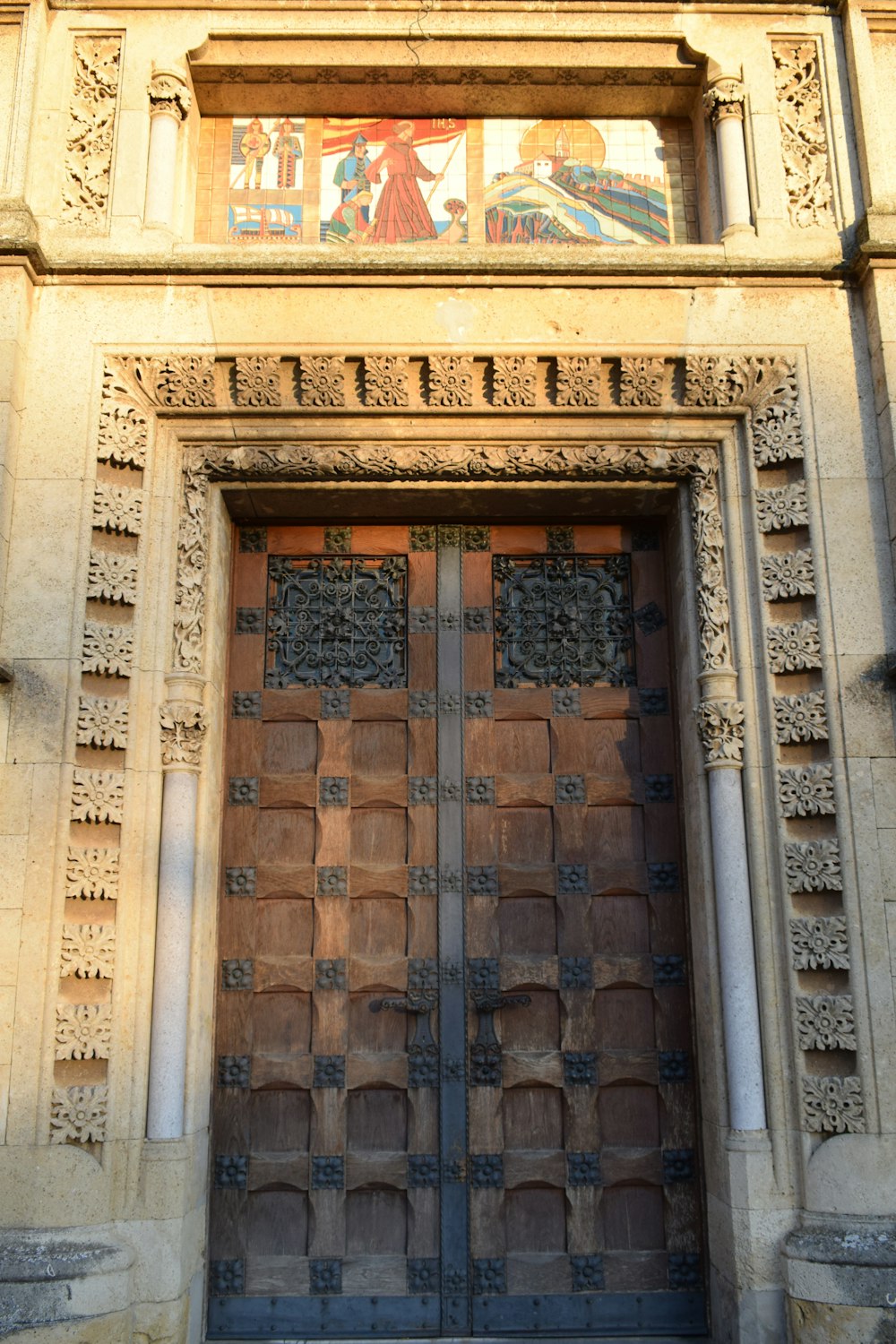 a tall building with a large wooden door