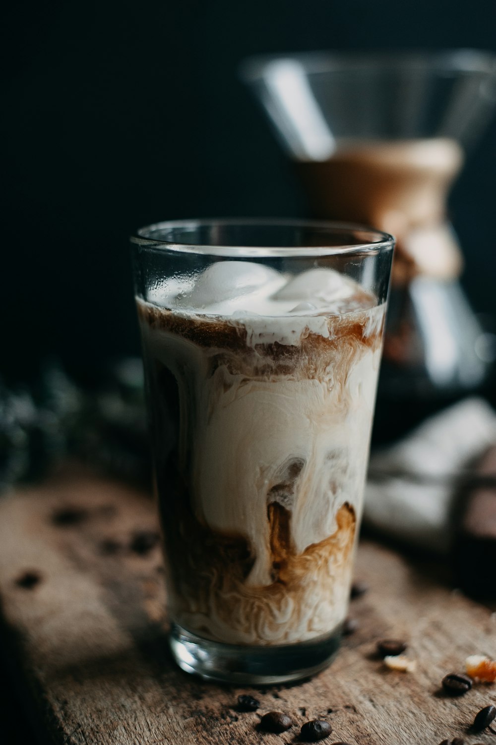 a glass of ice cream sitting on top of a wooden table