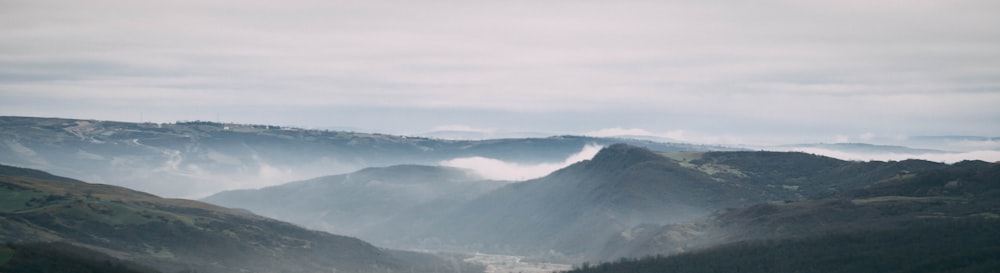 a view of a valley with mountains in the background