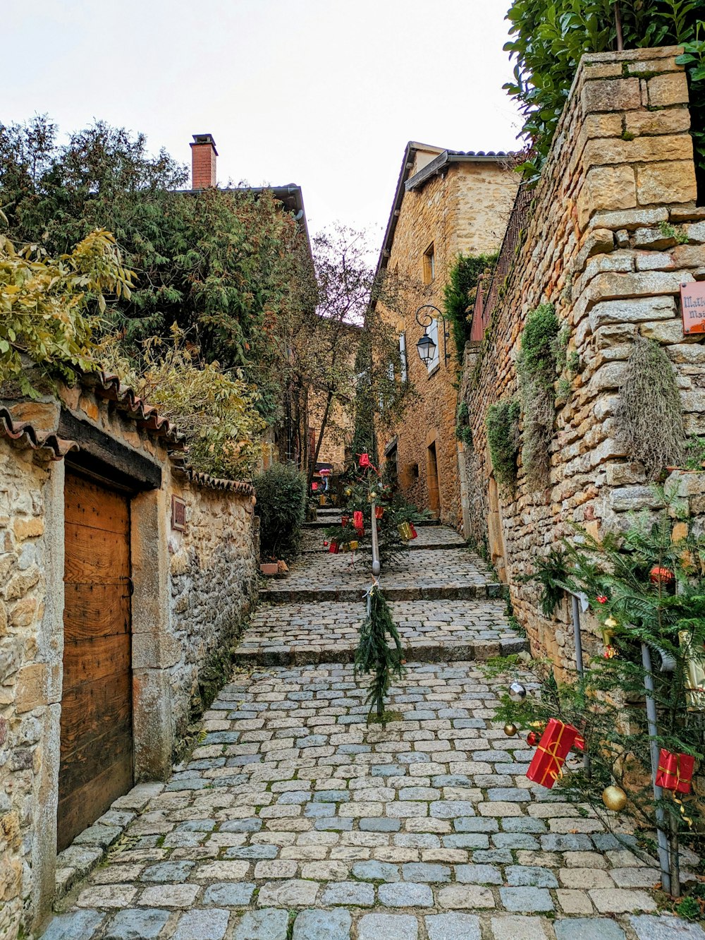 a narrow cobblestone street with stone buildings