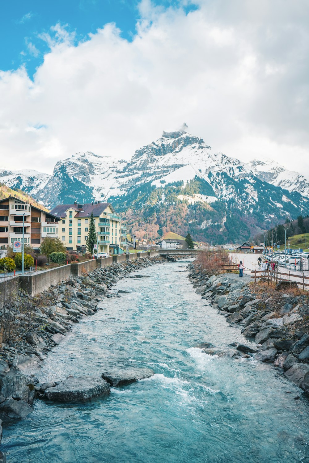 a river running through a city next to a mountain