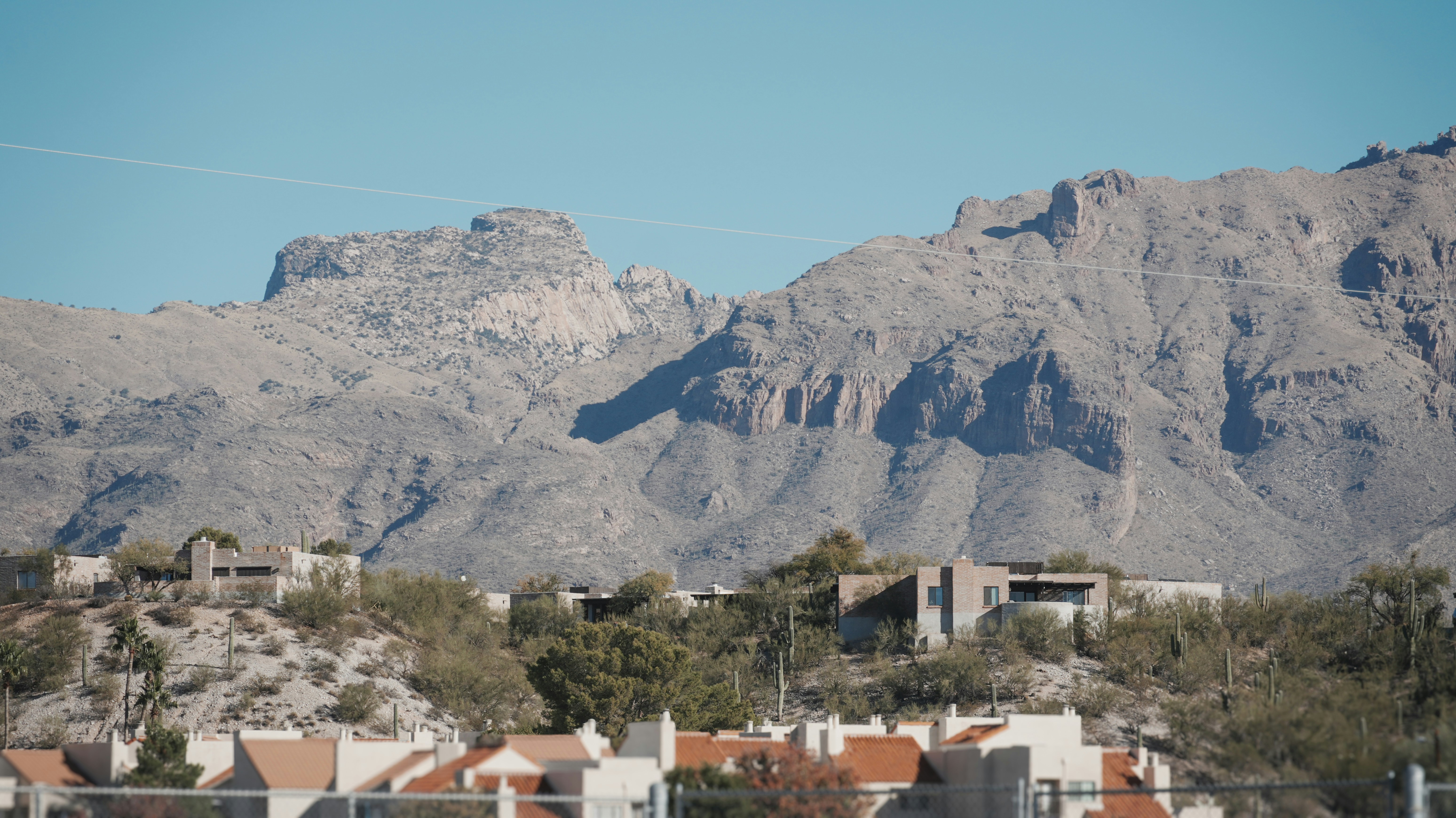 a view of a mountain range with houses in the foreground