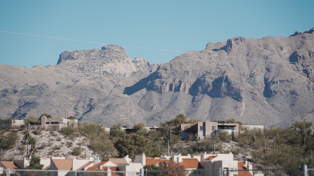 a view of a mountain range with houses in the foreground