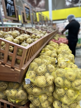 Stacks of freshly harvested potatoes packed in industrial crates at a sorting facility.