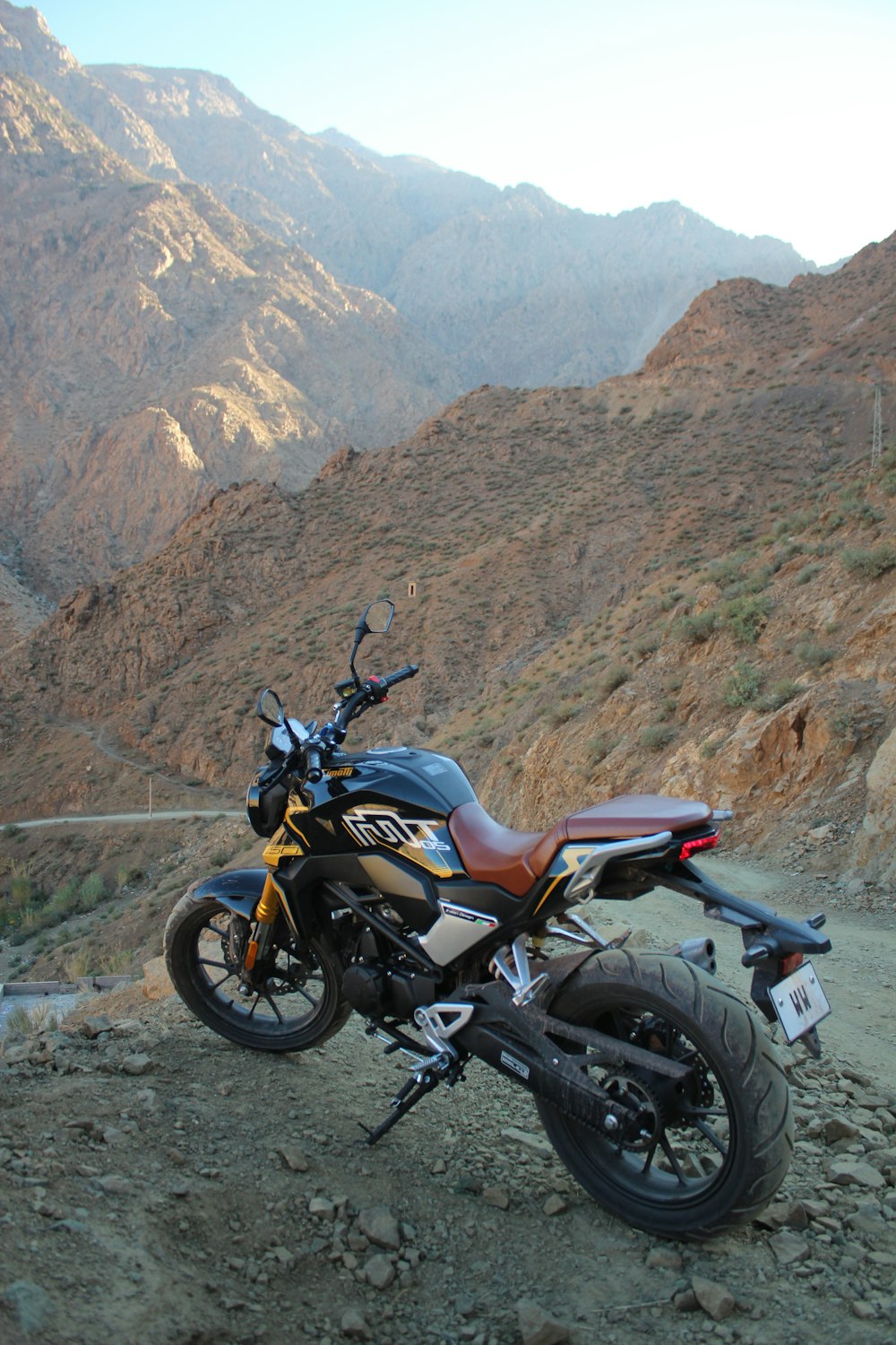 a motorcycle parked on the side of a mountain