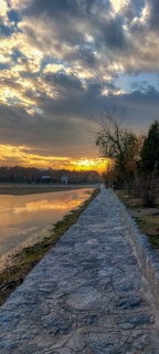 A vibrant sunset casting golden light over the retreat's natural stone pathways